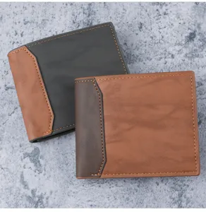 Detail of two men's bifold wallets in brown and grey PU leather with contrast stitching.