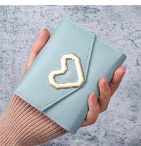 Detailed view of light blue leather wallet with a gold heart-shaped metal buckle