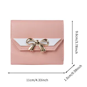 Elegant pink women's short wallet featuring a gold bow and clear size markings