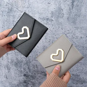 Fashionable black and grey mini wallets featuring elegant heart-shaped gold metal buckles