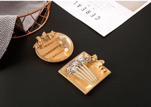 Vintage resin bow jewelry tray detail view, distressed gold finish tray for rings and earrings.