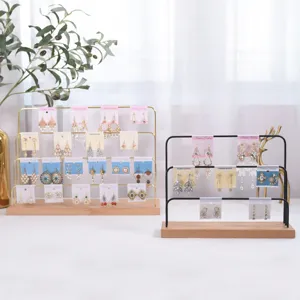 Multi-tier earring display stand with wooden base and metal jewelry organizer retail