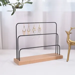 Detailed view of the multi-tier earring display stand with wooden base and metal bars.