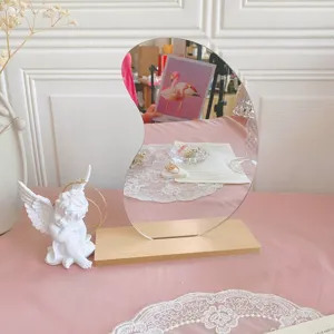 Irregular makeup mirror with wooden base, aesthetic ins desktop jewelry display prop.