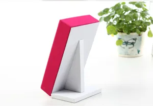 Detail view of hot pink velvet jewelry display stand with white support backing.
