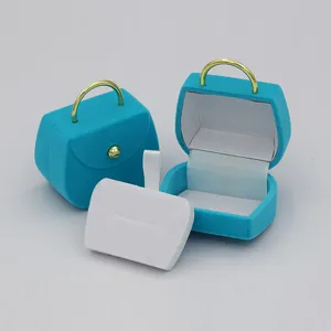 Blauer Samt Handtasche Schmuckkästchen für Ringe Ohrringe Halsketten mit goldenem Griff.