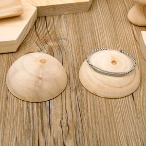 Wooden half-sphere jewelry display stand for bracelets and bangles, natural wood finish.
