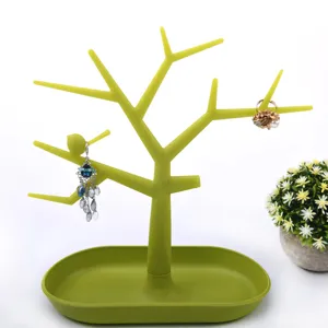 Green tree jewelry stand organizer with storage tray and bird decor for earrings display.