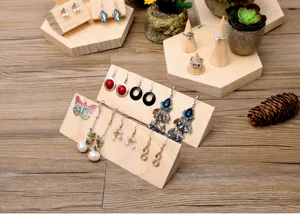 Wooden jewelry display stand detail showing multiple tiers for organizing earrings and rings securely.