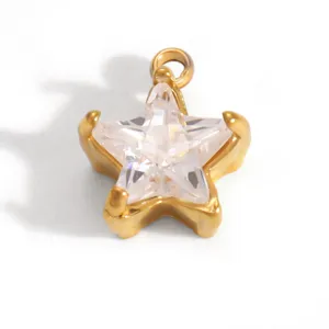 Macro detail view of a gold-plated stainless steel star pendant with clear crystal