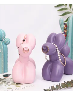Detailed view of Nordic balloon dog jewelry holders in pink and purple for cute desktop decor.