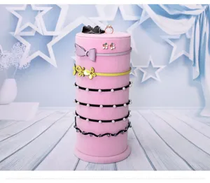 Pink velvet vertical headband holder jewelry display stand for earrings, rings and hair hoops.