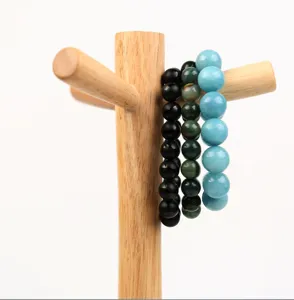 Solid wood jewelry display stand with beaded bracelets, minimalist natural wood finish for retail.