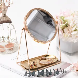 Elegant desktop makeup mirror with gold stand and storage tray, ideal for vanity table decor.