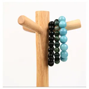 Natural stone bead bracelets set on wooden display stand, elegant jewelry presentation.