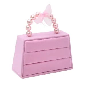 Roze fluwelen handtas sieradenopberger doos met parel handvat voor ringen oorbellen accessoires.