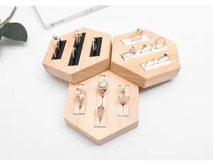 Detailed close-up of hexagonal solid wood ring display stand, neat velvet slots for jewelry.