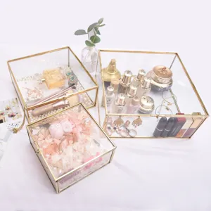 Nordic style glass storage box set with gold metal frame, clear jewelry and cosmetic display tray.