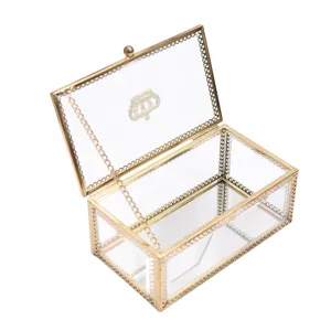 Vintage gold glass jewelry box with crown pattern and mirrored bottom for home decor.