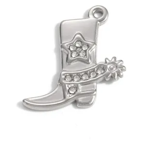 Detail view of a stainless steel cowboy boot pendant with rhinestone star and spur