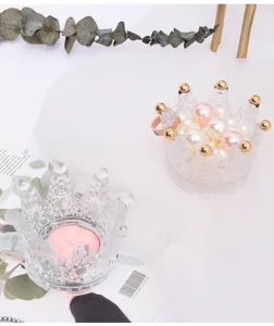 Glass crown candlestick holder and jewelry storage jar, elegant transparent design for home decor.