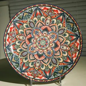 Detail shot of a 10-inch ceramic plate featuring vibrant bohemian mandala patterns.