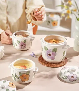 Ceramic stew pot with lid, dual handles, hand-painted floral design for home soup and dessert.