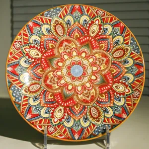 Close-up detail of a ceramic decorative plate featuring vibrant bohemian mandala design.