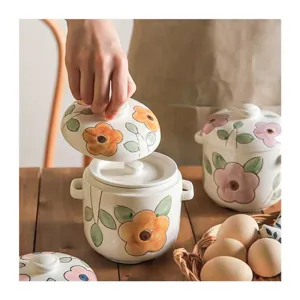Ceramic stew pot with lid and double ears, featuring a hand-painted floral design for home use.