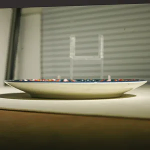 Ceramic plate side view showing edge thickness and Bohemian colorful rim pattern details.
