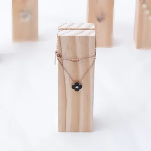 Exquisite rose gold black clover pendant necklace detail, elegant jewelry display.