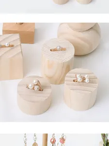 Solid wood ring display stand detail shot, natural wood grain square and round bases for jewelry.