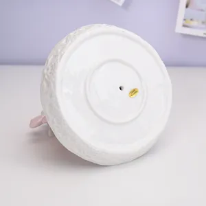 White ceramic bird jewelry display stand bottom view, elegant desktop ornament home decor.