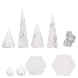 White marble resin jewelry display set including cone ring holders and trays for photography.