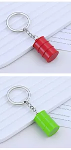 Detail view of creative red and green oil drum miniature keychain charms on white background