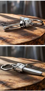Close-up of creative silver metal chainsaw keychain pendant on natural wood surface.
