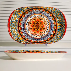 Bohemian ceramic oval fish plate detail showing intricate mandala floral pattern and shape.