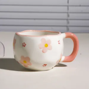 Taza de café de cerámica hecha a mano con bonito diseño de flores rosas, borde irregular.