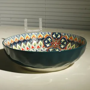 Detailed view of a large 10-inch ceramic salad bowl with vibrant bohemian floral patterns inside.
