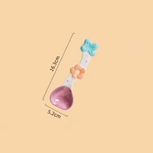Ceramic dessert spoon detail view, cute flower handle design, smooth purple scoop surface.