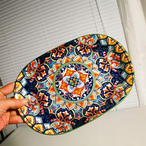 Stunning bohemian ceramic oval plate featuring vibrant Mediterranean floral and geometric patterns.