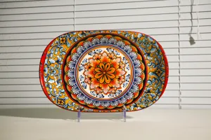 Close-up detail of bohemian style ceramic serving plate featuring vibrant mandala pattern.