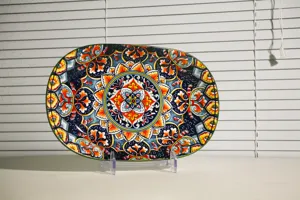 Ceramic oval serving plate with vibrant bohemian mandala pattern, perfect for kitchen and dining.