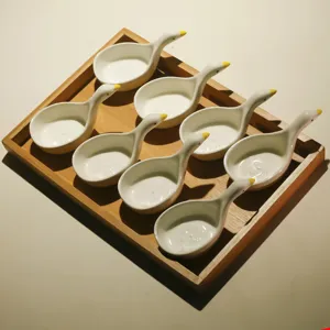 Cute ceramic little duck snack dishes set with wooden tray for tea and table decoration.