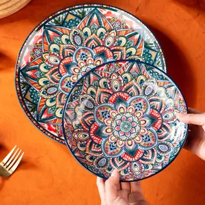Beautiful bohemian ceramic plate set with vibrant blue and red mandala patterns for dining.