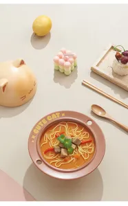 Detail view of ceramic cat instant noodle bowl set with chopsticks and cute props.