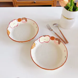 Hand-painted ceramic bowl with cute fruit cartoon relief design, ideal for salad or dessert.