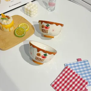 Handpainted ceramic strawberry bowl with cute chocolate drip design, perfect for dessert or salad.