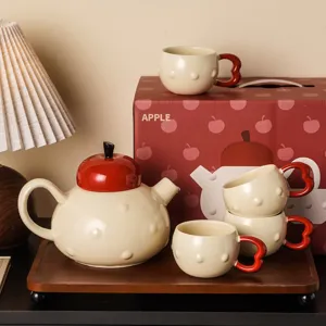 Ceramic apple teapot and teacup set with gift box, perfect for home and wedding gifts.