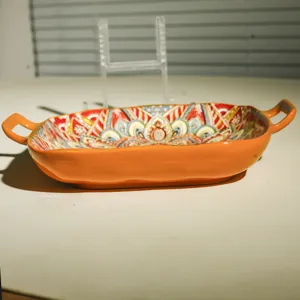 Close-up detail of the ceramic square baking dish with bohemian pattern and dual handles.